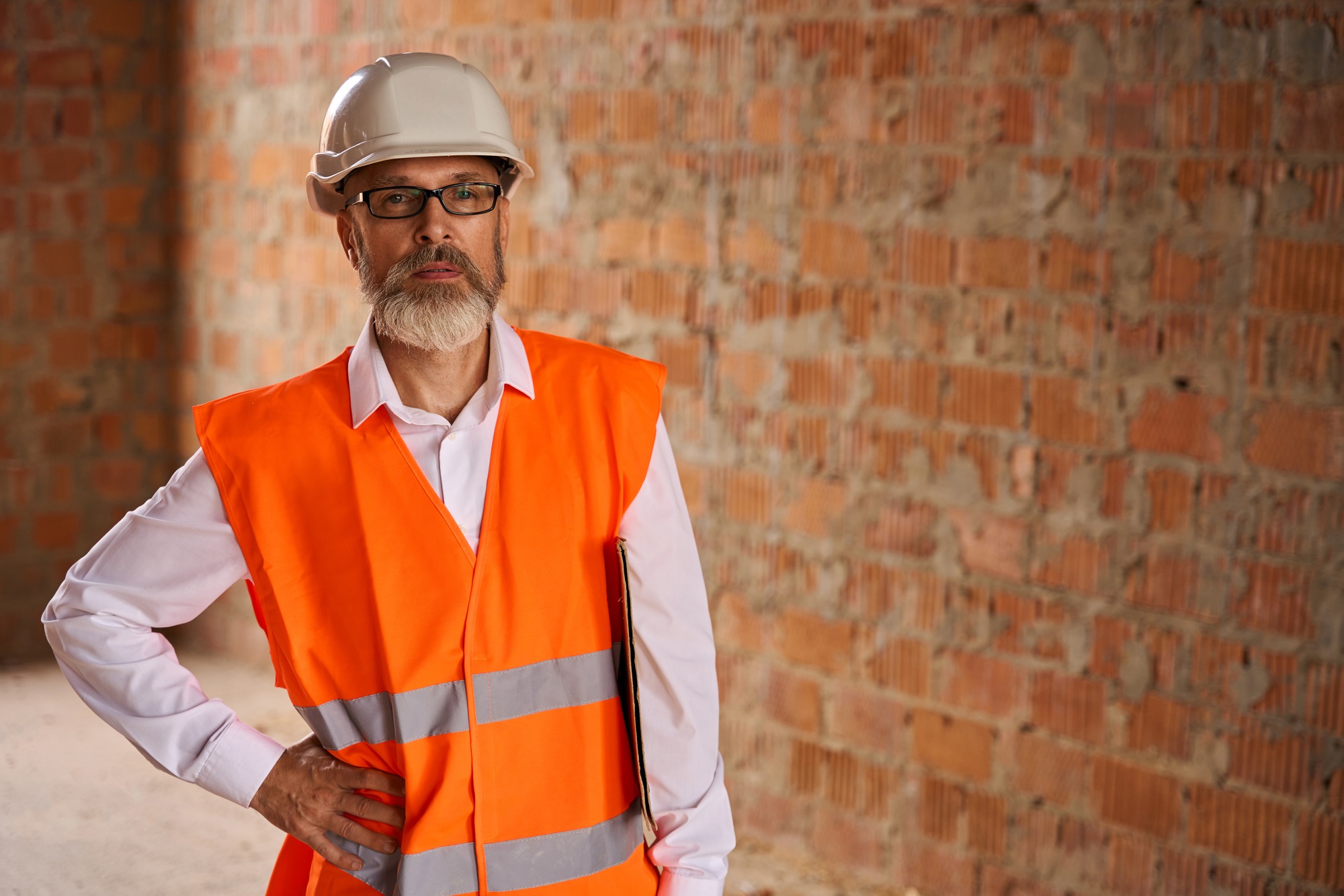 Construction superintendent posing for camera before building site inspection